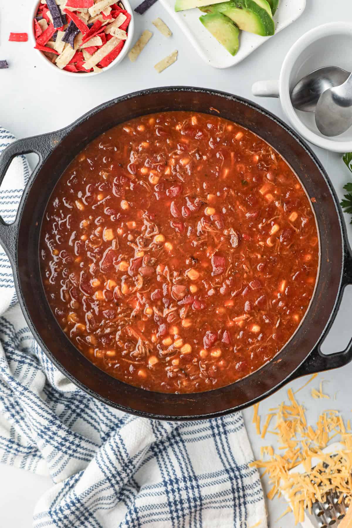 Adding additional ingredients to leftover pulled pork in the large stock pot for Pulled Pork Chili reipce