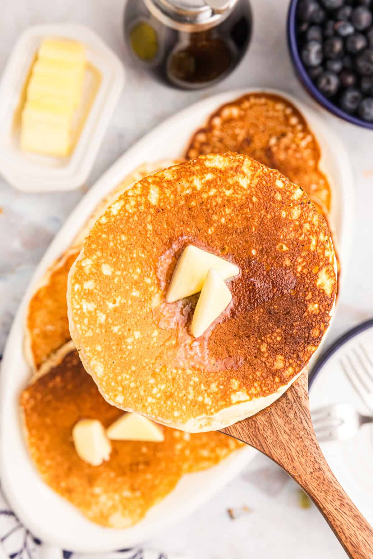 Blackstone Buttermilk Pancakes on serving platter with butter