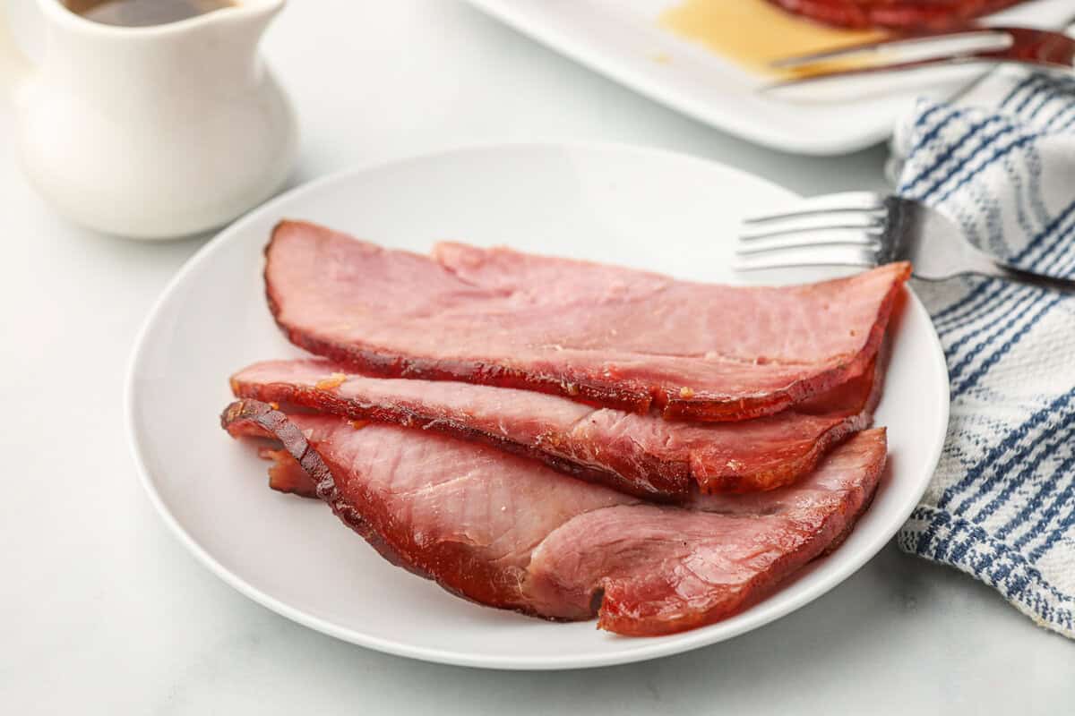 Sliced Double Smoked Ham with Glaze on white dinner plate