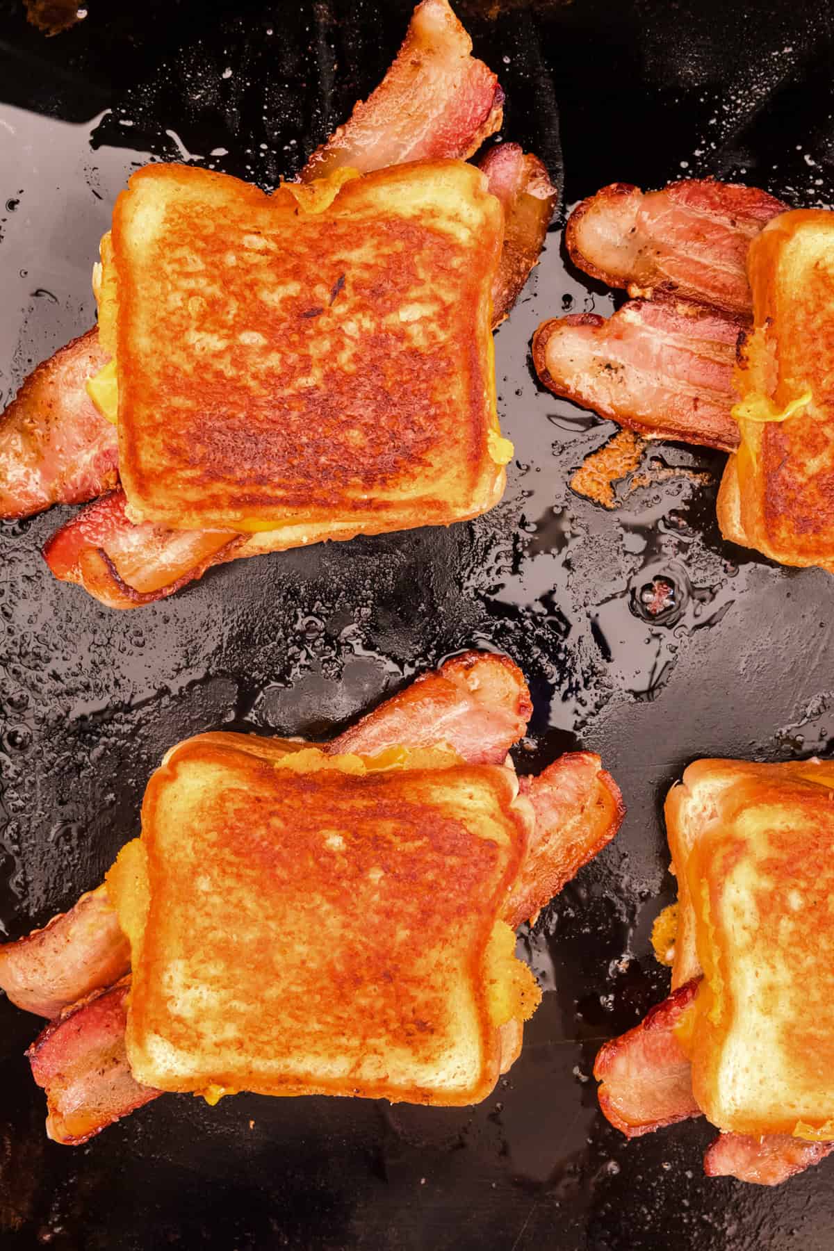 Overhead picture of fully cooked grilled cheese sandwiches on the blackstone.