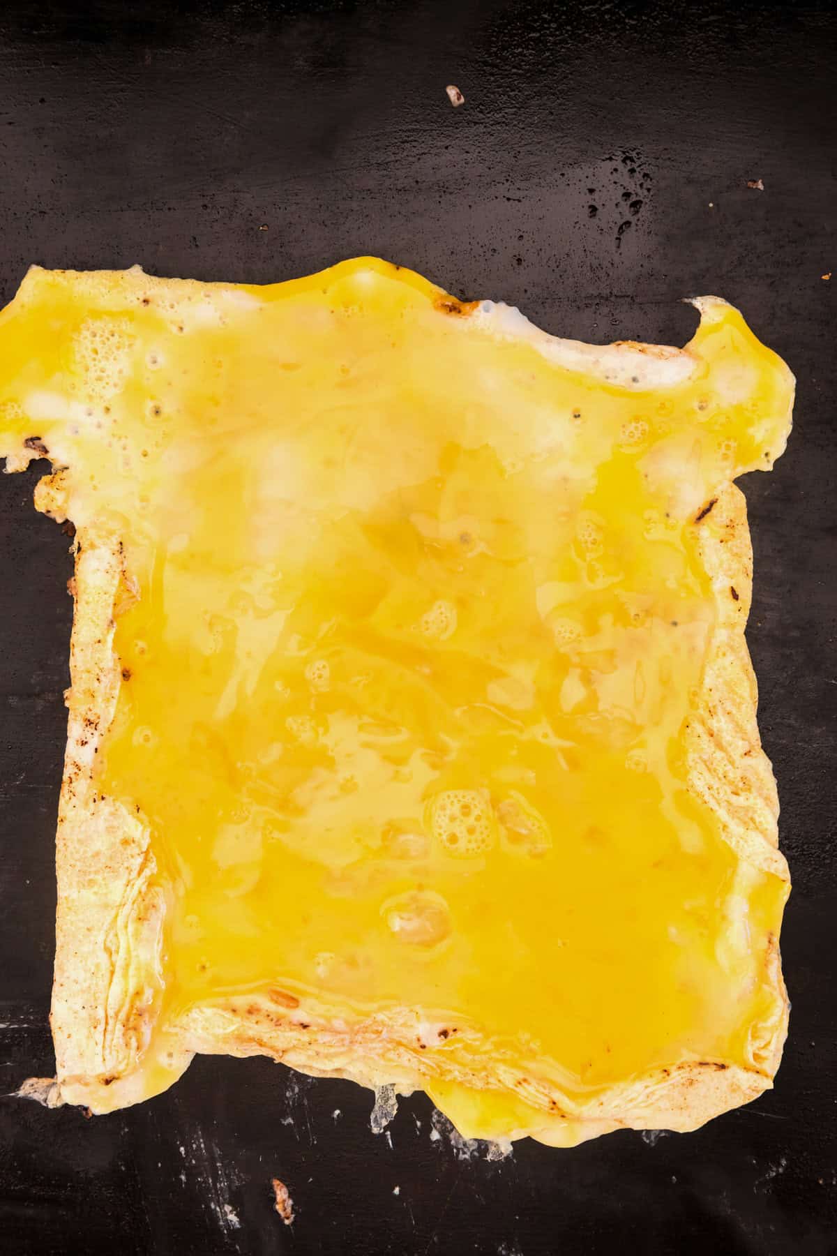 Scrambled eggs cooked in a rectangular shape on the Blackstone.