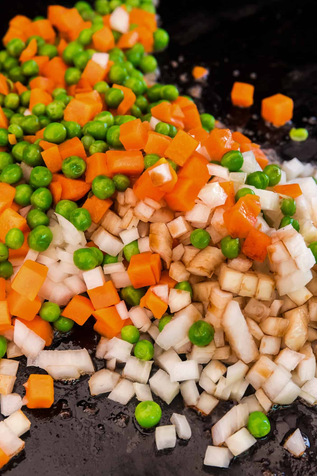 Onions, peas and carrots cooking on the Blackstone.
