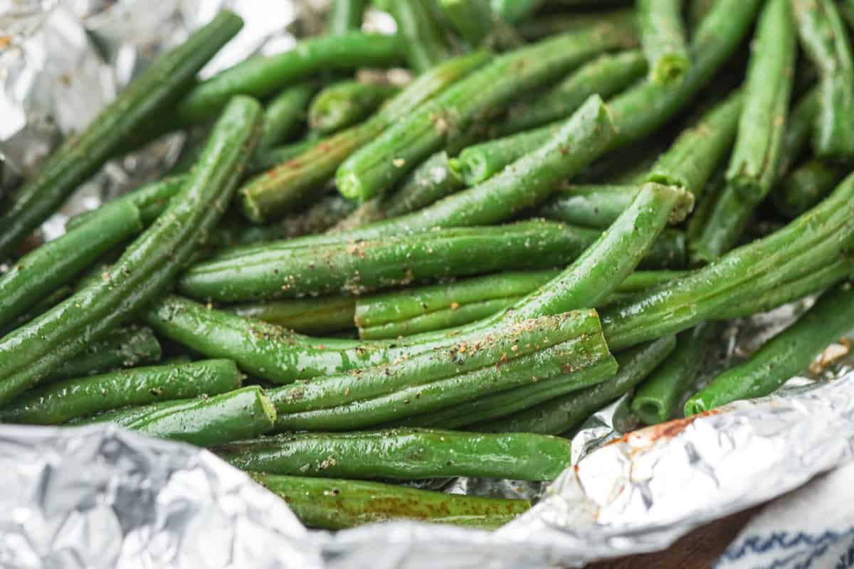 Close up of cooked green beans in foil.