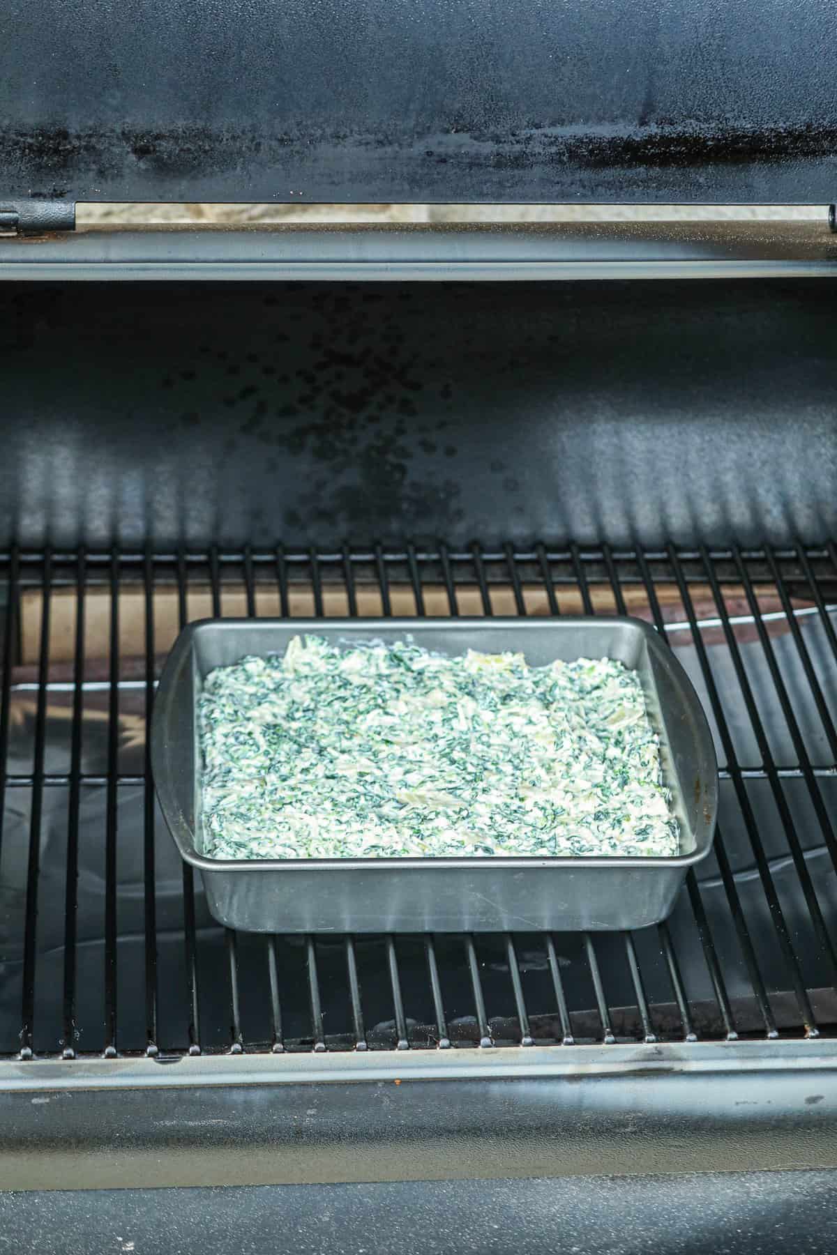 Spinach Artichoke Dip in the smoker uncooked.