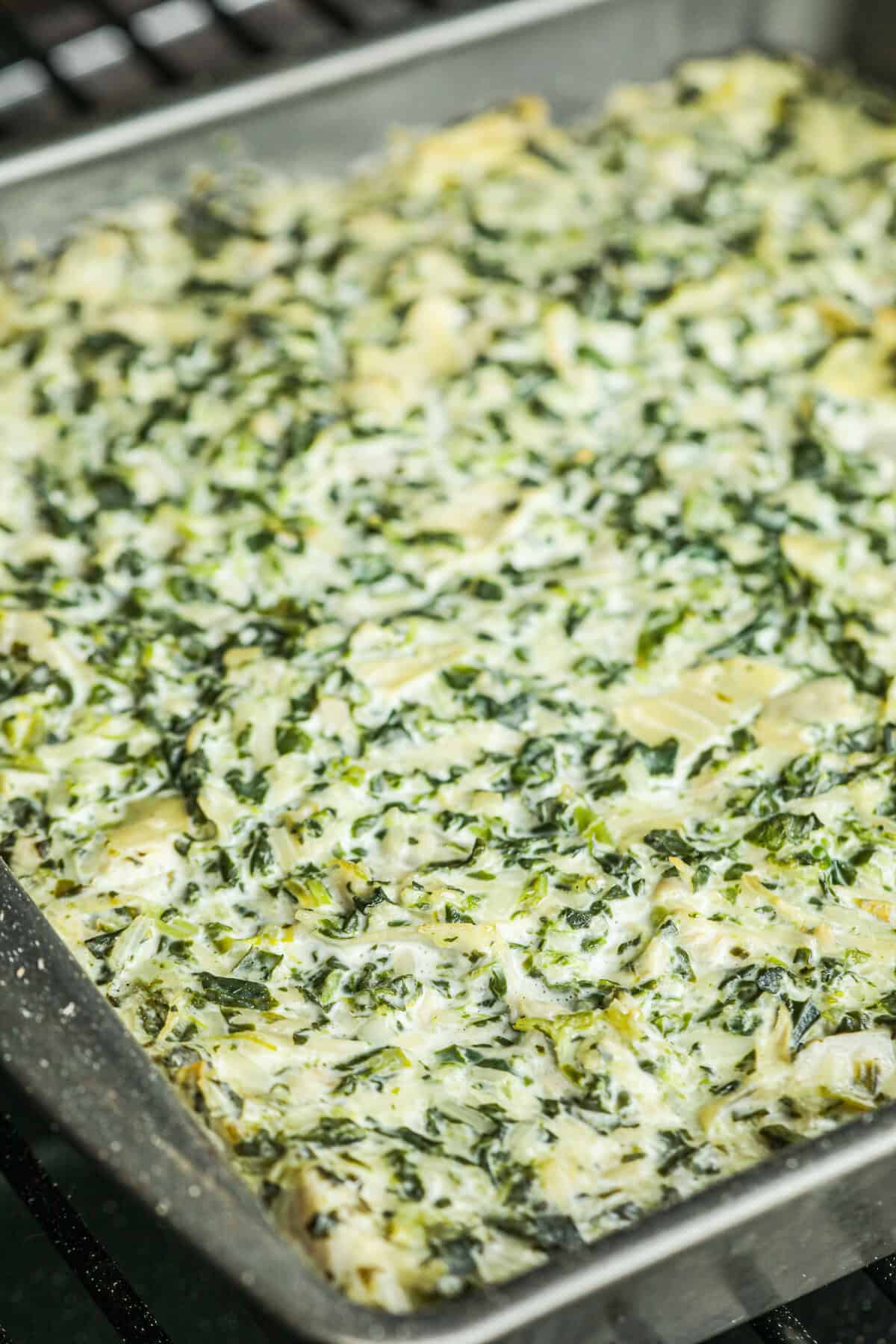 Close up picture of cooked Spinach Artichoke Dip.