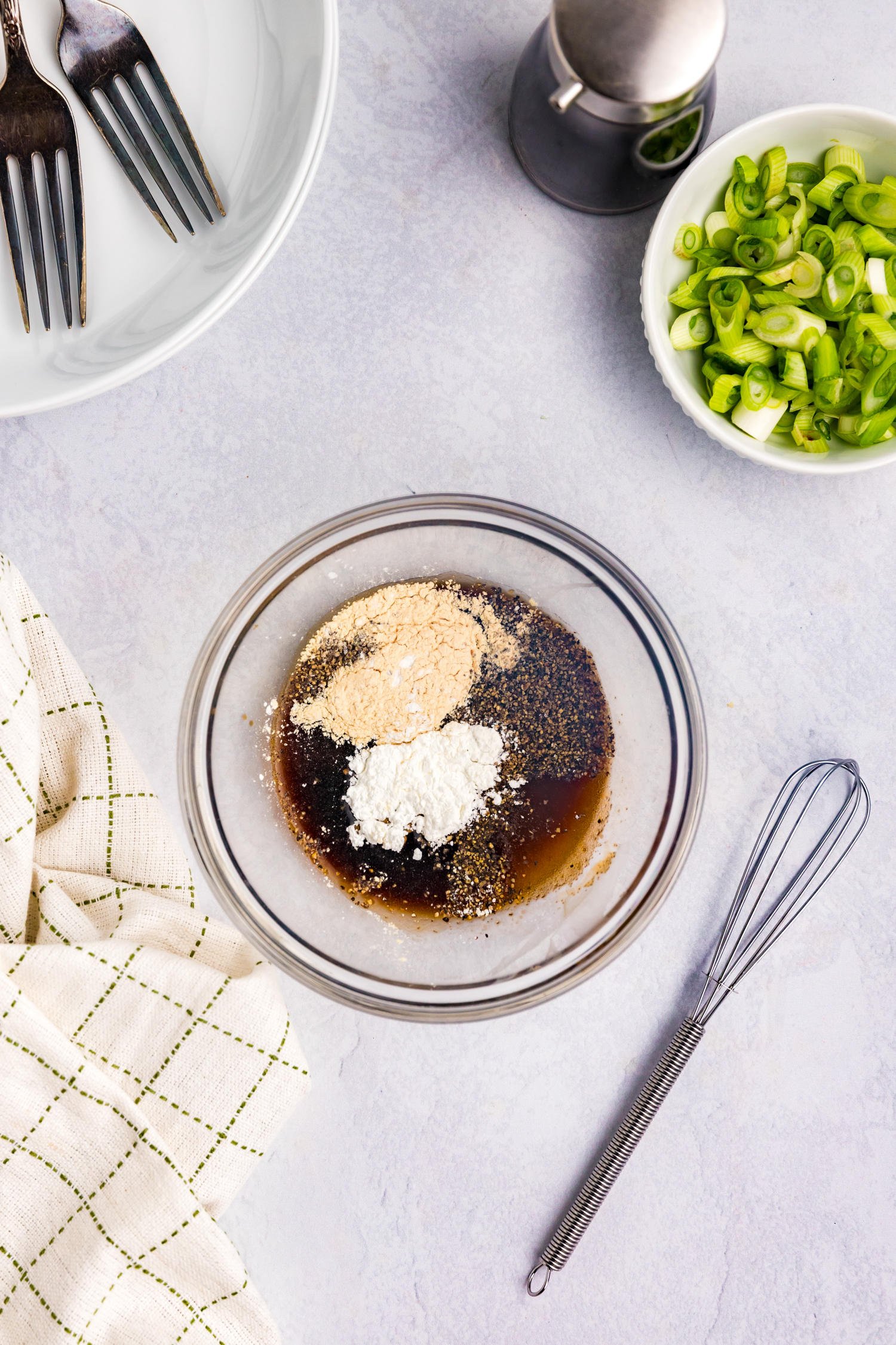 Overhead picture of unmixed sauce ingredients in a glass bowl.