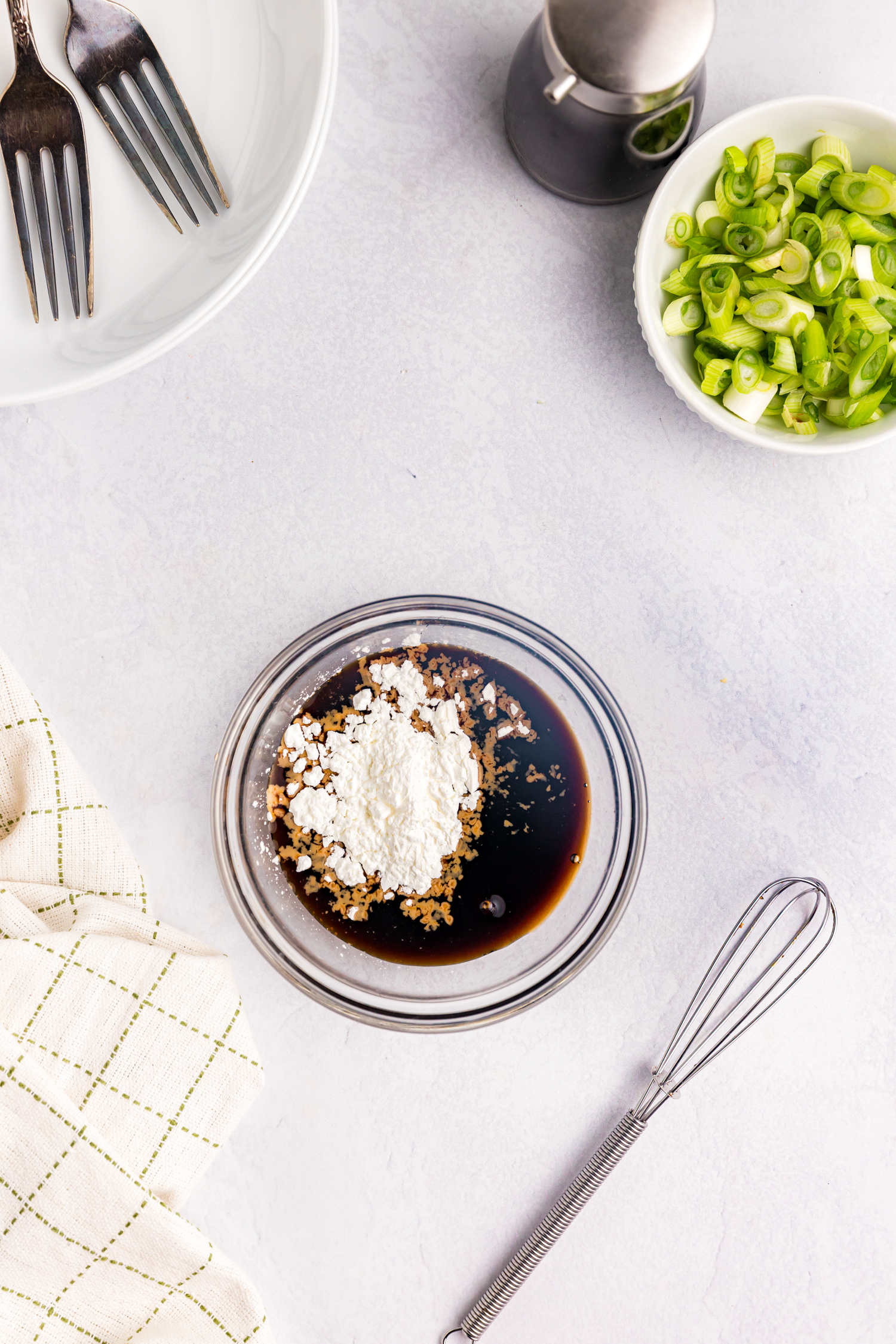 Overhead picture of glass bowl with sauce ingredients in it.