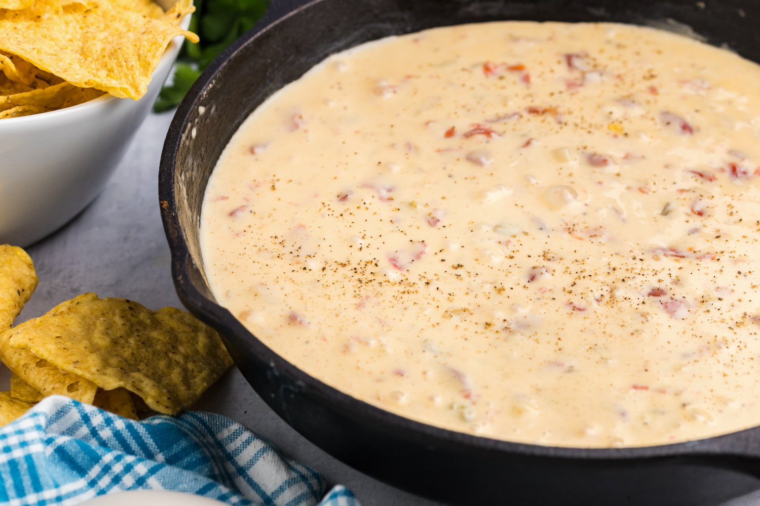 Close up picture of completed Blackstone Queso in a cast iron skillet.