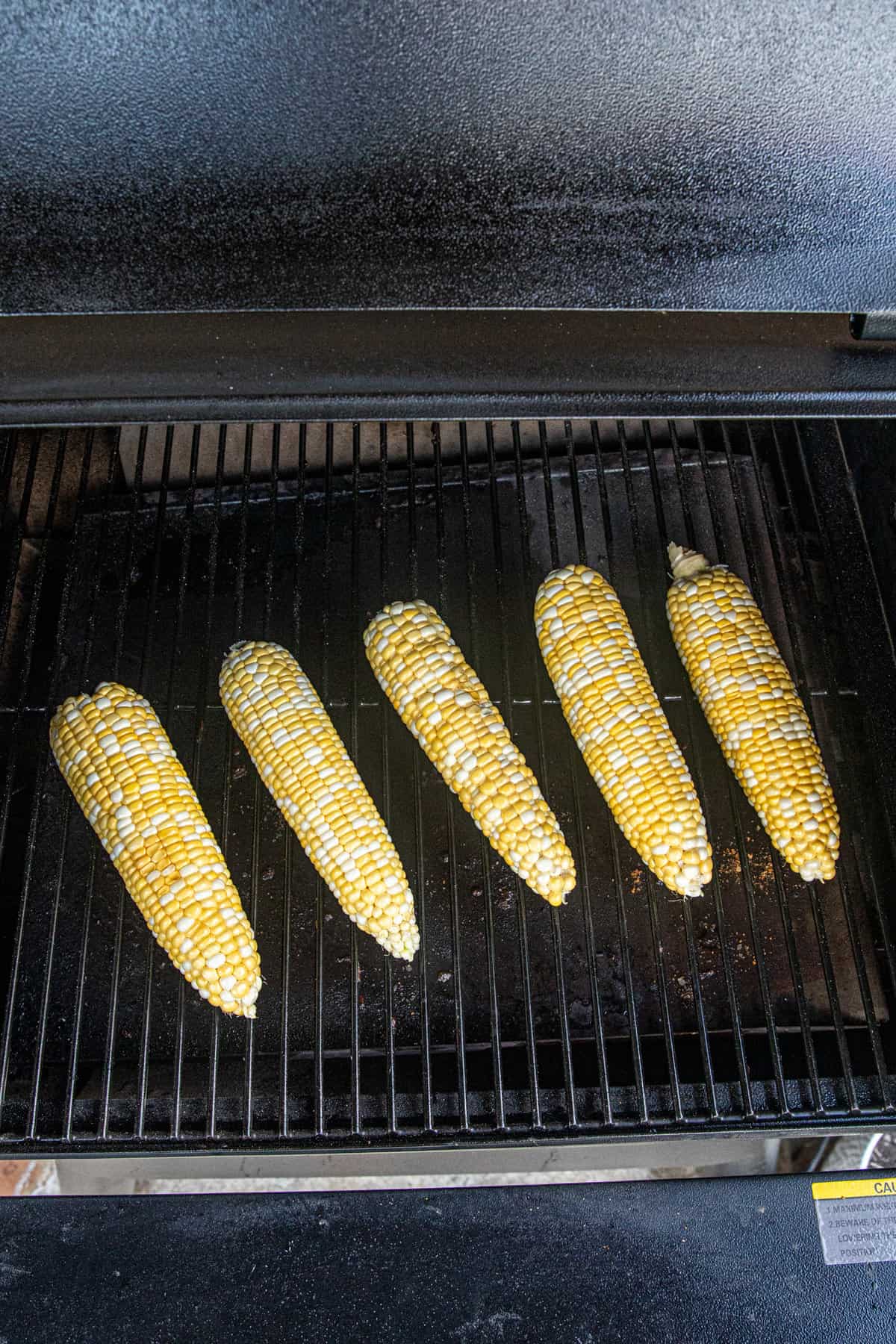 Buttered corn on smoker for Smoked Corn on the Cob recipe