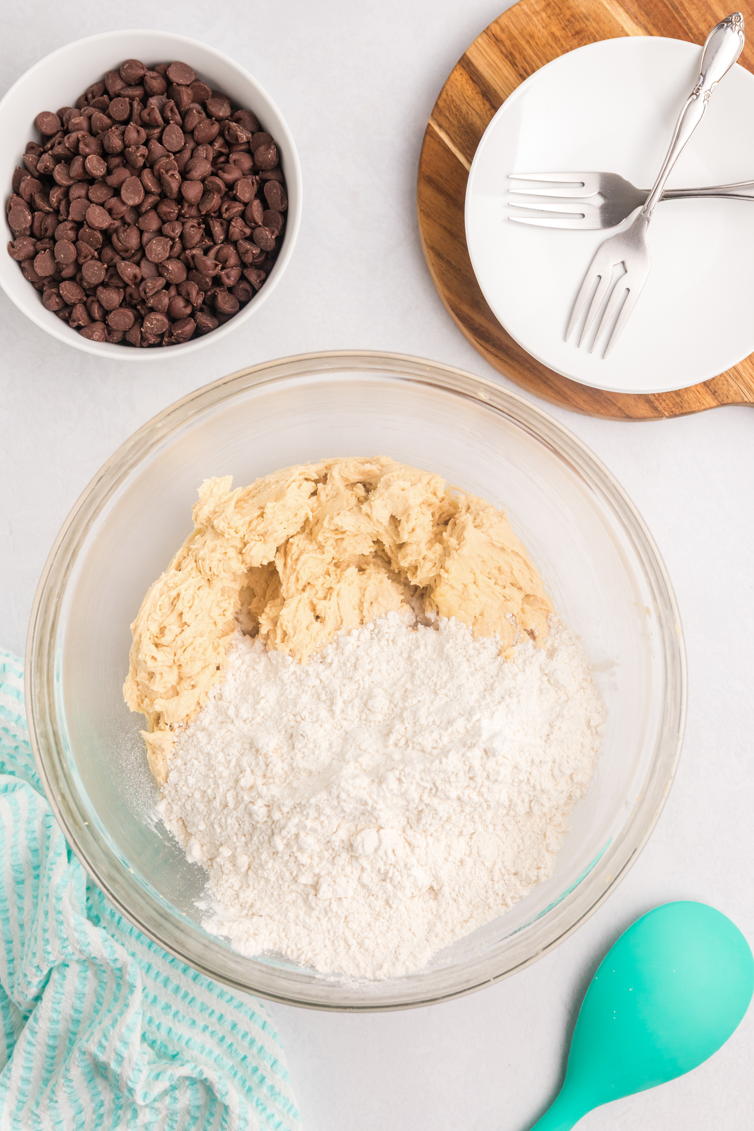 The cookie dough mixture is partially combined, and the dry flour mixture has been added to the bowl, ready to be incorporated.