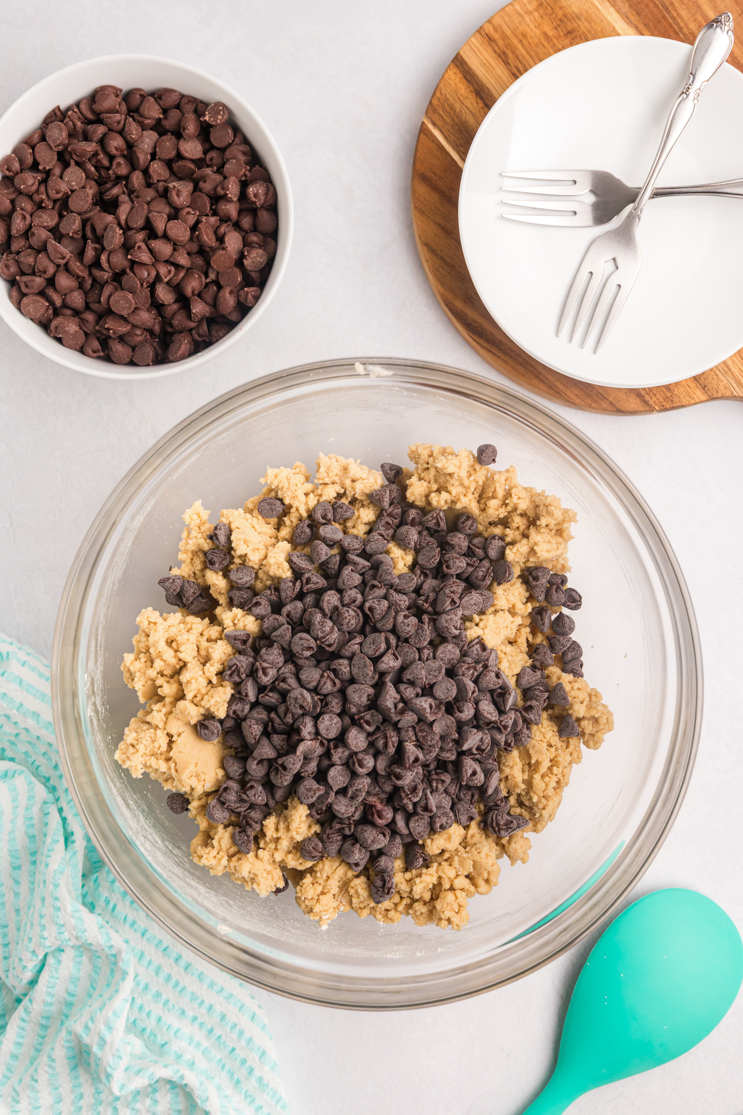 The dough is now fully mixed, and chocolate chips have been added to the top, not yet stirred in.