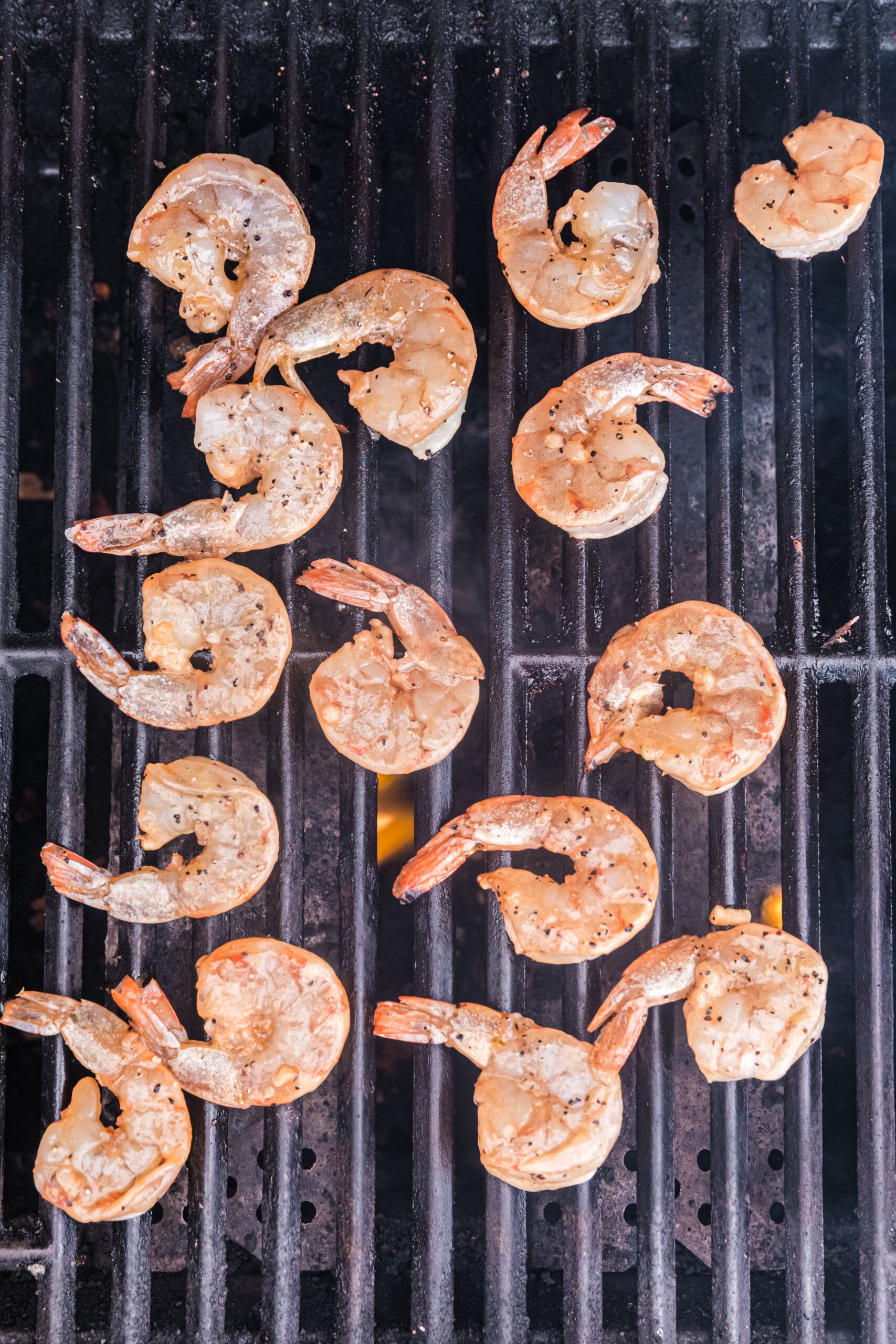 Marinated shrimp placed on a hot grill for cooking