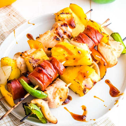 Chicken and Sausage Kebabs on white plate