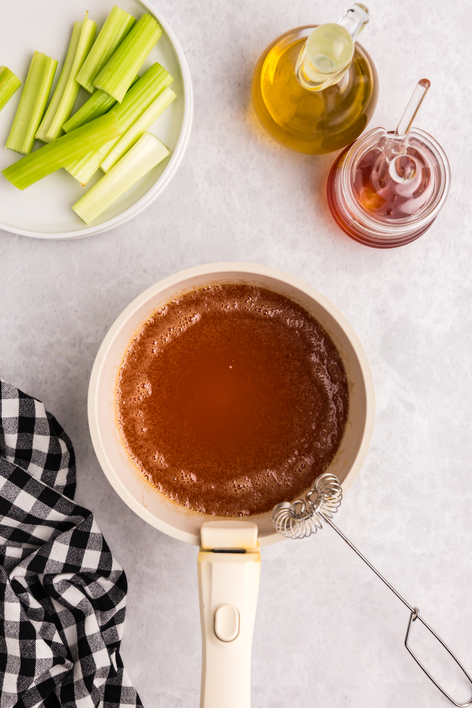Sauce fully melted and combined, forming a smooth hot honey glaze in a saucepan.