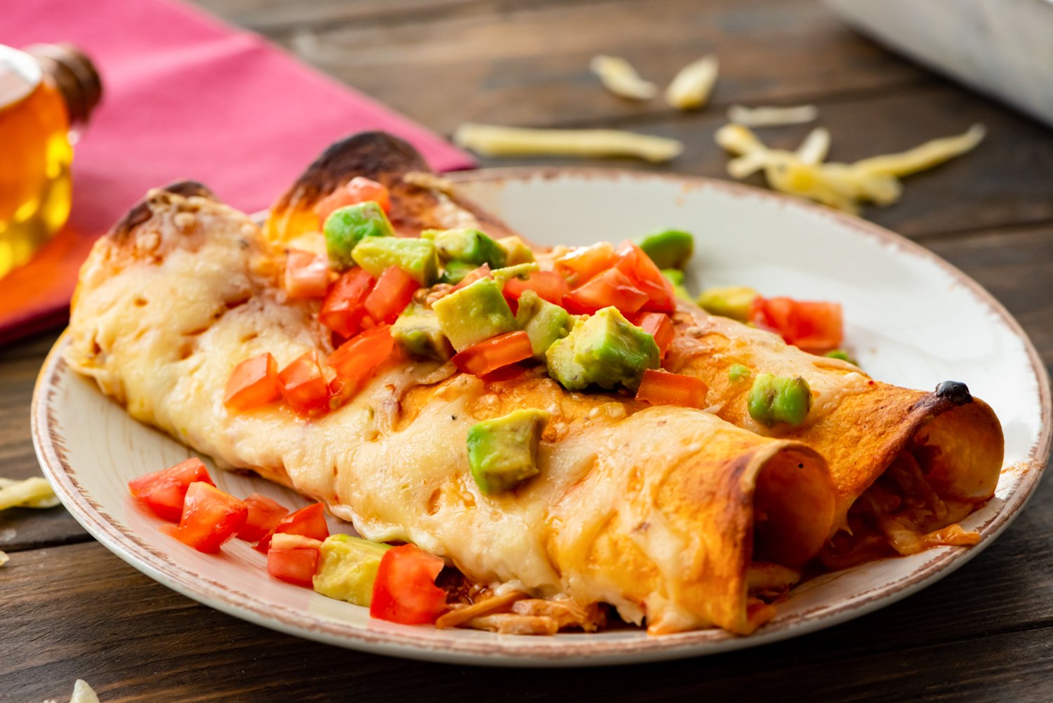 Two pulled pork enchiladas on a plate