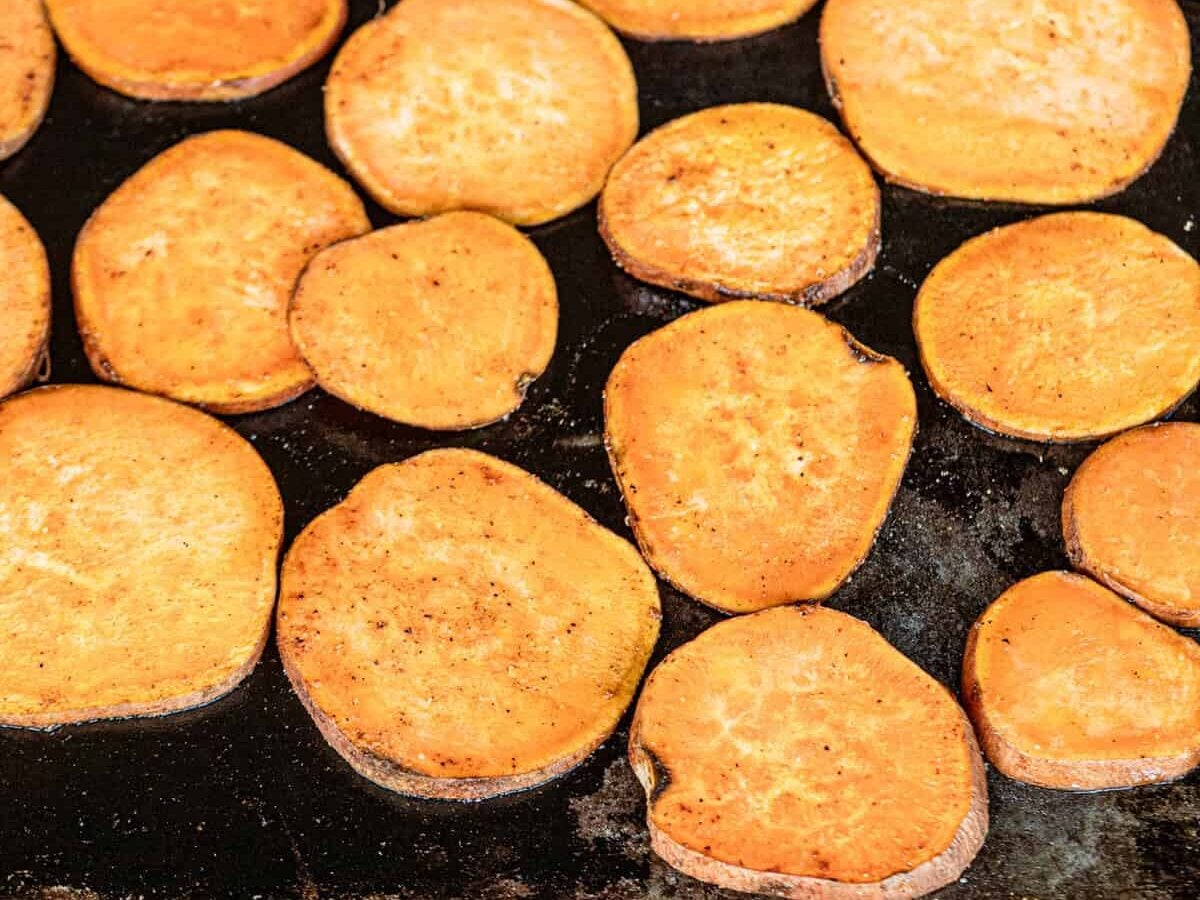 Seasoned sweet potato slices on grill for Grilled Sweet Potatoes
