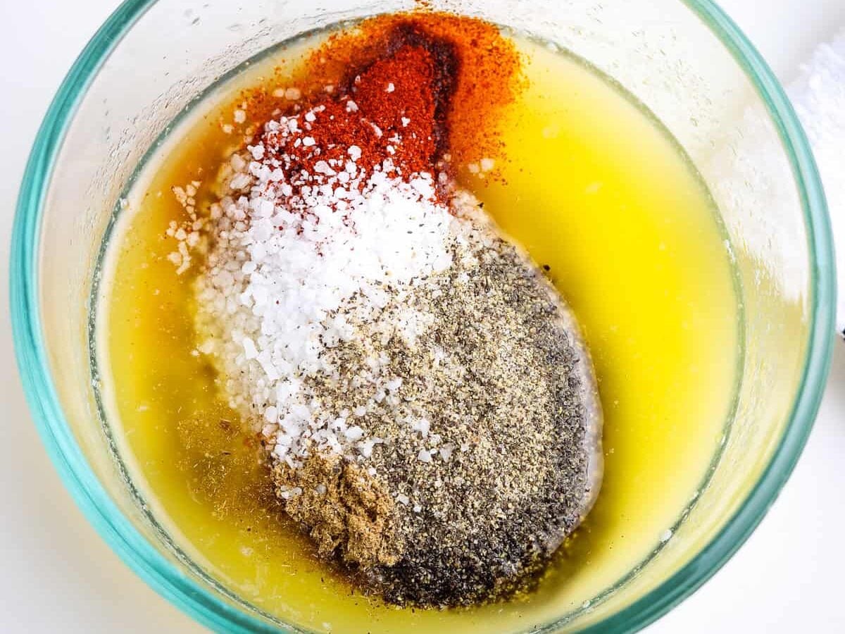 Glass bowl with melted butter and seasonings