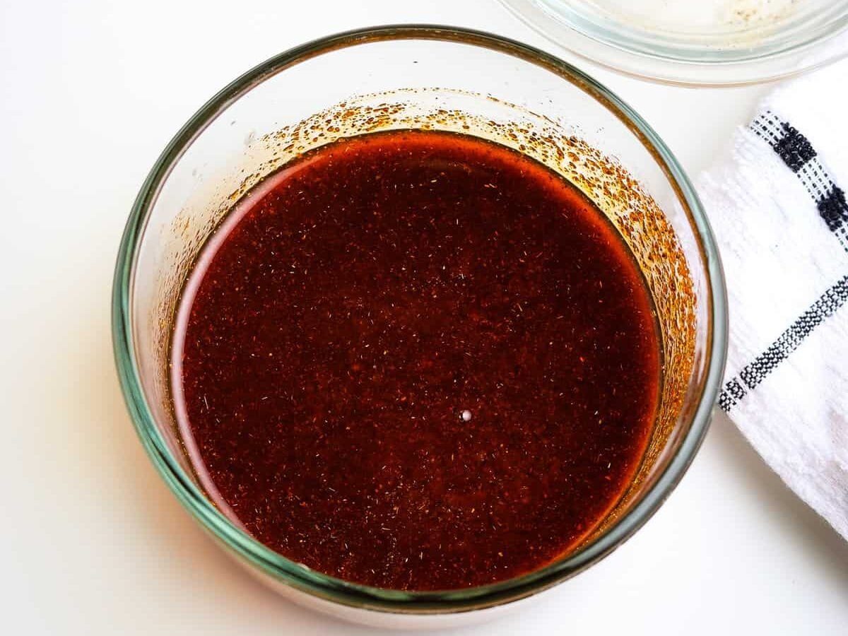 Glass bowl with melted butter and seasonings stirred together