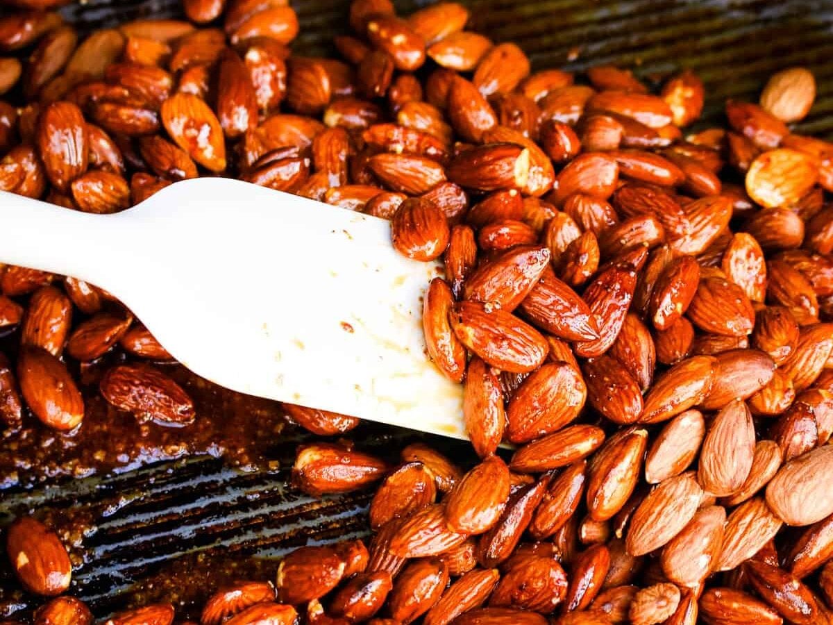 Stirring almonds and seasonings on smoker