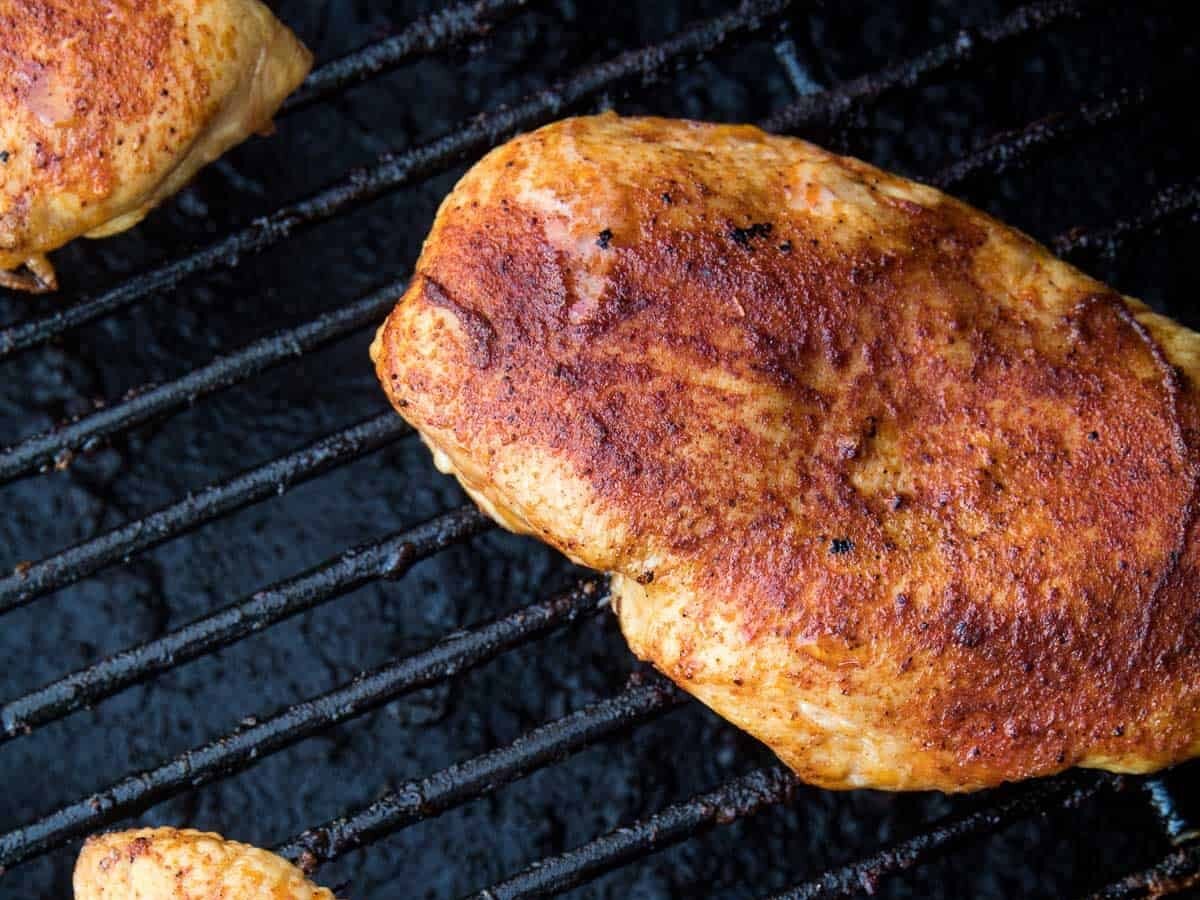Seasoned chicken breasts on Traeger smoker