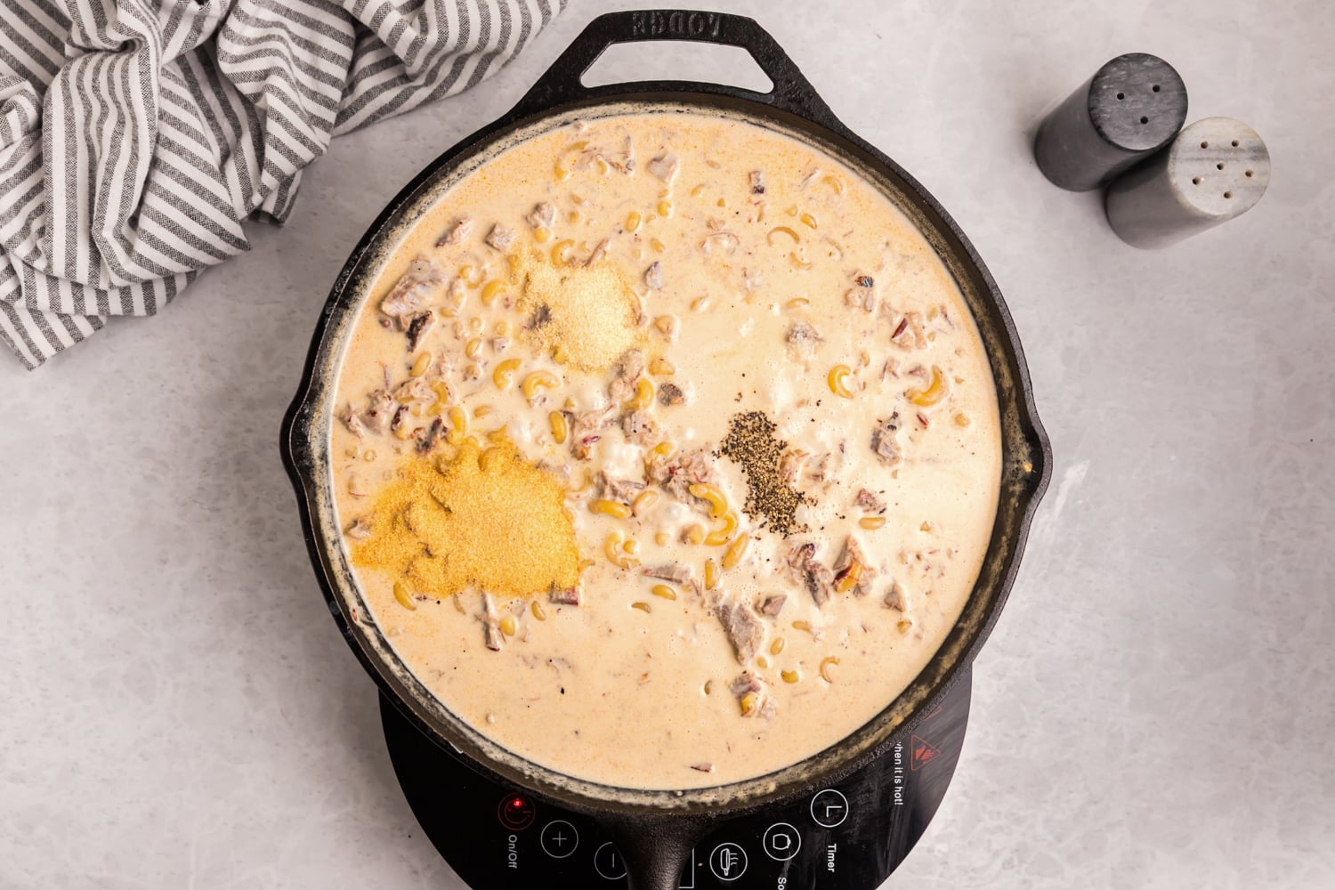 Brisket, macaroni, creamy cheese sauce and seasonings combined in a skillet.