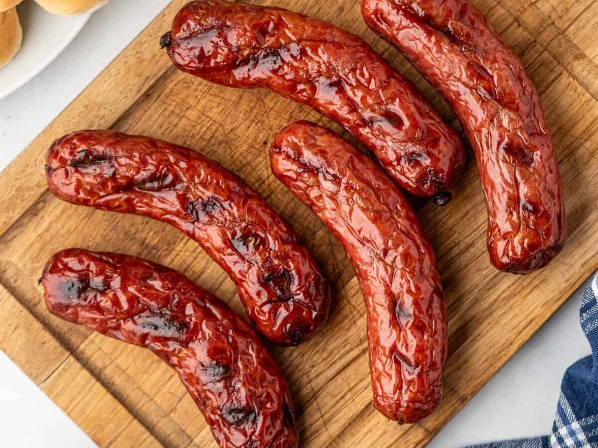 Smoked Sausge hot off the grill ready to serve from a wooden cutting board