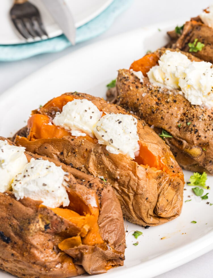 Smoked sweet potatoes split open and topped with butter, salt and pepper.